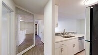 Located at 1538 N Vista St in the heart of West Hollywood, CA, this one-bedroom, one-bathroom unit offers a well-designed single-floor layout with a clean, modern aesthetic throughout. Light wood-style flooring flows seamlessly across all rooms, creating a cohesive and contemporary look.

The combined kitchen and living area forms the central hub of the unit. The galley-style kitchen is thoughtfully appointed with white shaker cabinetry extending to the ceiling, a mosaic tile backsplash, white quartz countertops, a double stainless steel sink, and a full suite of black and stainless steel appliances including a gas range, microwave, and refrigerator. The adjacent living room provides an open, airy feel with access to a door that brings in natural light.

The bedroom offers a comfortable, well-proportioned retreat with a built-in closet and a window that provides natural light. The room's neutral white walls and wood-style flooring maintain the clean, uniform character of the unit. A large decorative mirrored panel in the hallway adds depth and a stylish accent to the transitional space.

The bathroom features a full tub-shower combination with floor-to-ceiling textured tile surround with a built-in niche, a white toilet, and wood-style flooring, delivering a polished and cohesive finish throughout.