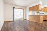 Located at 1224 Mark Ave in Tomah, Wisconsin, this two-story home offers a practical and well-organized layout spread across two floors. The main level hosts the primary living areas, including a combined kitchen and living room that serves as the heart of the home. The kitchen is outfitted with warm oak cabinetry, light countertops, a double sink, and white appliances including a range and refrigerator. Wood-look vinyl flooring runs throughout the main level, lending a cohesive and easy-to-maintain finish. A dedicated entrance provides a welcoming transition into the home, and an attached garage with an automatic opener adds convenient, sheltered parking. Two hallways connect the various spaces efficiently on each level. Upstairs, two carpeted bedrooms offer comfortable retreats, each featuring closet storage — with a total of six closets distributed throughout the home. The primary bedroom is generously proportioned with its own dedicated closet access. Two full bathrooms, each equipped with a tub-shower combination, wood-toned cabinetry, and wood-look flooring, serve the home's occupants. Neutral white walls and warm wood trim accents carry throughout, creating a clean and consistent aesthetic from top to bottom.