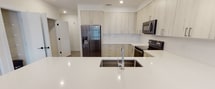 Located at 3718 University Dr in Durham, NC, this single-floor residence showcases a clean, contemporary design with consistent finishes throughout. The open-concept layout is anchored by a spacious living area with light wood-style flooring, recessed lighting, and a generous bank of windows that invite abundant natural light and provide views of the outdoors. A sliding glass door connects the living space to a private balcony.

The kitchen is well-appointed with light wood cabinetry extending to the ceiling for maximum storage, white quartz countertops, a undermount sink, and stainless steel appliances including a refrigerator, range, and microwave. Pendant lighting adds a modern touch overhead.

Bedrooms feature plush carpeting, ceiling fans, and large windows with exterior views. The primary suite includes a walk-in closet with wire shelving and an en-suite bathroom with granite countertops, light wood cabinetry, matte black fixtures, and a glass-enclosed shower. A secondary bathroom offers a granite-topped vanity and a tub-shower combination. A dedicated laundry room houses a full-size washer and dryer with overhead shelving, completing this well-designed residence.