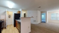 Located at 9901 Gable Ridge Terrace in Rockville, Maryland, this single-floor residence offers a practical and well-organized layout designed for comfortable everyday living. The kitchen is outfitted with warm wood cabinetry, a gas range, black appliances including a full-size refrigerator, and a granite-style countertop peninsula that opens toward the living area — creating a natural flow between cooking and living spaces. A dedicated utility closet off the kitchen provides in-unit laundry hookups for added convenience. The living area is generously proportioned, featuring neutral wall-to-wall carpeting, a ceiling fan, and a large window that draws in ample natural light while offering views of the surrounding greenery. Track lighting in the adjoining area adds functional illumination. The bedroom is a calm, well-lit space with plush carpeting and a window fitted with blinds overlooking lush outdoor scenery. The bathroom includes wood-toned flooring, a vanity with a wide mirror, a built-in linen closet with wire shelving for organized storage, and a tiled shower-tub combination. Throughout the unit, clean white walls and light-toned finishes create a bright and neutral interior ready for personalization.