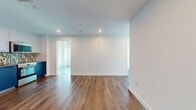 This contemporary 730 square foot apartment offers a blend of style and functionality. Located at 1300 Fairmount, unit 553, the space boasts three bedrooms and three bathrooms on a single floor. The primary bedroom, measuring 160 square feet, provides a spacious retreat.

Throughout the apartment, large windows frame stunning city views, flooding the rooms with natural light and creating an open, airy ambiance. The sleek, modern design is evident in every detail, from the pristine white walls to the gleaming hardwood floors that run throughout the living areas and bedrooms.

The kitchen showcases a modern aesthetic with its blue cabinetry, stainless steel appliances, and eye-catching mosaic tile backsplash. Bathrooms feature a clean, contemporary look with blue tiled walls, white fixtures, and ample storage space.

Each bedroom offers generous proportions and large windows, ensuring comfort and brightness. The open-plan living area seamlessly connects to the kitchen, ideal for entertaining or relaxed day-to-day living.

This apartment combines urban sophistication with practical living, offering a perfect balance of style, comfort, and convenience in a prime city location.