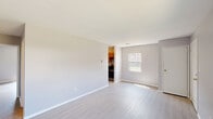 Located at 1020 Oaklawn Ct in Fort Wayne, Indiana, this single-floor, 1-bedroom, 1-bathroom unit offers a practical and well-organized layout. The living room is the largest area of the home, featuring light-toned luxury vinyl plank flooring, neutral warm-gray walls, and clean white trim throughout, creating a bright and cohesive atmosphere. A window allows natural light to filter in, with views of the surrounding greenery outside.

The kitchen is a galley-style space equipped with warm oak cabinetry, dark countertops, a double-basin sink, a gas range, and a refrigerator, with a hallway leading further into the unit. The bedroom is a comfortable, private retreat with its own closet featuring a hanging rod, continuing the same LVP flooring and neutral tones found throughout the home. Windows in the bedroom offer views of the outdoor surroundings.

The bathroom includes a vanity with wood cabinetry, a white countertop, a toilet, and a tiled shower-tub combination. Notably, the unit includes four closets spread throughout, providing generous storage options. The overall design is clean and functional, making efficient use of the available space.
