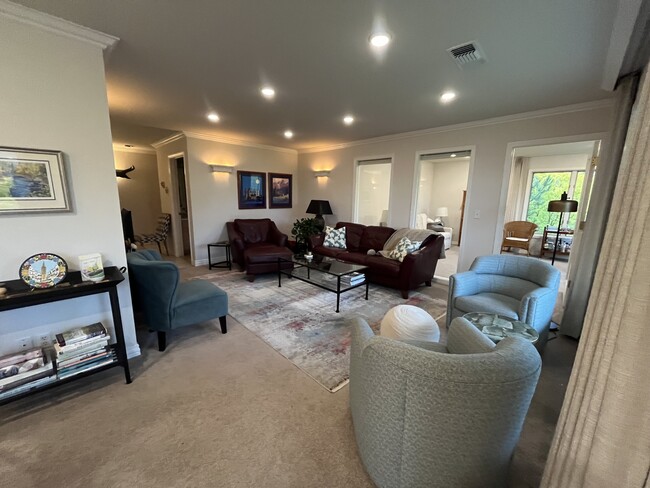 Living room with den/2nd bedroom pictured through windows. - 1725 Elison Ln