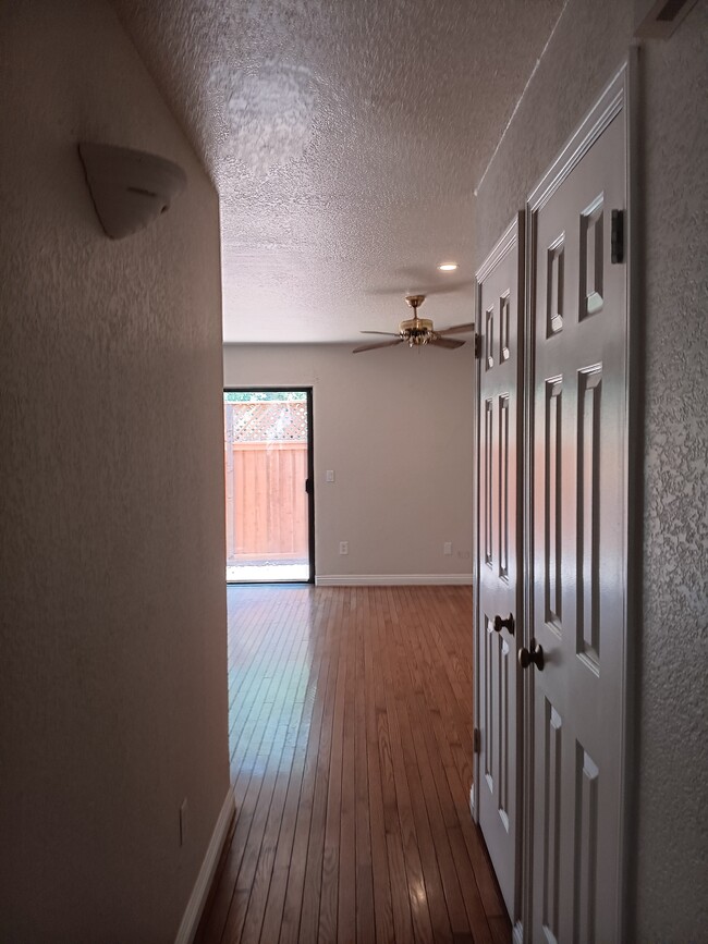 Living Room w/ view of high new fence for added security - 1964 Windmill Cir