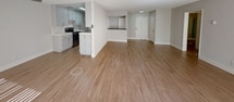 Located at 6000 Buckingham Pkwy in Culver City, California, this single-floor residence offers a clean, contemporary design with a bright and airy atmosphere throughout. The open-concept living and dining area features warm wood-tone flooring, neutral gray walls, and large sliding glass doors fitted with vertical blinds that allow generous natural light to pour in. A ceiling fan adds practical comfort to the living space, while a built-in bar-height counter provides a seamless transition to the kitchen area. The kitchen is well-appointed with white shaker-style cabinetry, white quartz countertops, a stainless steel electric range, and wood-tone flooring, creating a fresh and functional cooking environment. The bedrooms feature plush carpeting, large windows with vertical blinds, and sliding closet doors, offering a quiet and comfortable retreat. The bathrooms are thoughtfully designed — one features a tub-shower combination enclosed by frosted sliding glass doors alongside a vanity with white cabinetry, while another offers a dual-sink vanity with gray countertops, white cabinetry, and direct access to a walk-in closet. Textured ceilings are consistent throughout, and the overall neutral color palette provides a versatile, move-in-ready canvas.
