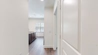 This well-designed apartment offers 1010 square feet of contemporary living space across a single floor. The open-concept layout seamlessly integrates the kitchen, living, and dining areas, creating a spacious feel. The kitchen boasts modern wood cabinetry, stainless steel appliances, and a convenient island with a sink and extra counter space.

Both bedrooms are generously sized, with the primary bedroom measuring 160 square feet. Large windows in each room provide abundant natural light and scenic views. The two full bathrooms feature sleek vanities with ample storage, modern fixtures, and a combination of shower and bathtub options.

Throughout the apartment, warm wood-look flooring adds a touch of elegance and continuity. Ceiling fans in the main living areas and bedrooms ensure comfort and air circulation. The neutral color palette of whites and soft grays creates a versatile backdrop for various decor styles.

Additional features include recessed lighting, window blinds for privacy, and strategically placed closets for storage. The apartment's layout maximizes functionality while maintaining a sense of openness and flow between spaces.