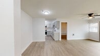 Located at 3735 Trilling Ave, Unit 207 in Rockford, IL, this 2-bedroom, 1-bathroom unit offers a clean, modern aesthetic throughout its efficiently designed single-floor layout. Light-toned luxury vinyl plank flooring runs consistently through every room, creating a cohesive and easy-to-maintain living environment.

The living area is bright and open, featuring a ceiling fan with light fixture and a sliding glass door that leads to a private balcony, filling the space with natural light. Adjacent to the living area, the kitchen stands out with crisp gray shaker-style cabinetry, marble-look countertops, a matte black faucet and hardware, and stainless steel appliances including a range and over-the-range microwave — a well-appointed space for cooking and entertaining.

Both bedrooms are comfortably sized, each equipped with ceiling fans and natural light from windows with blinds. The primary bedroom features a double-door closet, while the second bedroom offers a mirrored sliding closet door and baseboard heating. The full bathroom is neatly finished with a gray shaker-style vanity, a medicine cabinet with mirror, matte black fixtures, and a tub/shower combination with tile surround. The unit combines functional design with updated finishes throughout.