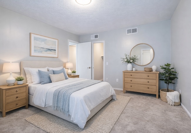 Calm neutral bedroom with cozy accents - Lexington Springs Apartments