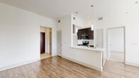 Located at 2222 Smith St in Houston, TX, this one-bedroom, one-bathroom unit offers a thoughtfully designed single-floor layout that maximizes functionality and comfort. The open-concept living and dining area is bathed in natural light from large windows with blinds, and features warm hardwood-style flooring that flows throughout the main living spaces. The kitchen serves as a central hub, showcasing dark espresso cabinetry, stainless steel appliances including a range, microwave, and refrigerator, and a peninsula with a built-in sink and pendant lighting above — ideal for casual dining or entertaining. A dedicated office provides a versatile workspace separate from the main living areas. The bedroom is carpeted for comfort and connects directly to the full bathroom, which features a long vanity with dual sinks, dark cabinetry, a large mirror, tile flooring, and a walk-in tiled shower with decorative tile accents. Generous storage is provided throughout, with four closets including a spacious walk-in closet outfitted with wire shelving. Additional conveniences include an in-unit laundry area and a pantry. The clean white walls and consistent design palette give the entire space a bright, modern, and cohesive ambiance.