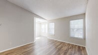 Located at 675 Jamestown Blvd in Altamonte Springs, FL, this one-bedroom, one-bathroom unit offers a well-organized, single-floor layout designed for comfortable everyday living. The open living area greets you with warm wood-look flooring, neutral-toned walls, and multiple windows dressed with horizontal blinds that allow generous natural light to fill the space. A vaulted ceiling accent near the entryway adds a sense of openness, while a textured ceiling and ceiling fan in the bedroom provide both style and comfort.

The kitchen is thoughtfully appointed with white shaker-style cabinetry, subway tile backsplash, granite countertops, and a breakfast bar peninsula. Black appliances, including a refrigerator and electric range, complete the functional cooking space.

The bedroom is a comfortable size, featuring wood-look flooring, a ceiling fan with light fixture, and windows on two walls that invite natural light. A dedicated walk-in closet offers dual hanging rods and shelving on both sides, providing ample storage.

The bathroom includes a full tub-shower combination with clean white tile surrounds. A separate laundry area houses a full-size washer with built-in wire shelving above. The overall aesthetic is clean, modern, and move-in ready.