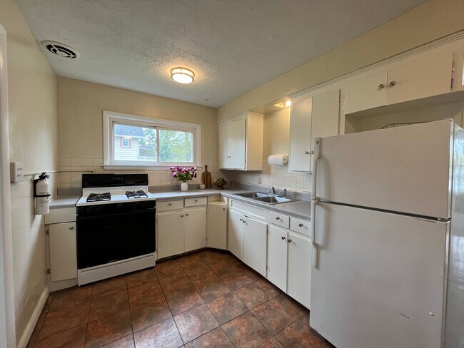 Warm kitchen with just painted cabinets. - 800 W Riddle Ave
