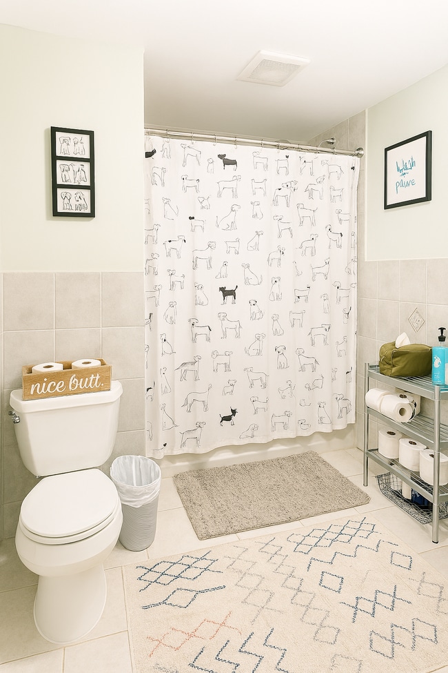 Lower-level bathroom with a full tub, located just off the kitchen with a vented exhaust fan. - 56 Jefferson Ave