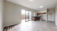This well-appointed 2-bedroom, 2-bathroom residence at 3630 Gillham Rd in Kansas City, Missouri offers a thoughtfully designed single-floor layout with modern finishes throughout. The open-concept living and kitchen area is anchored by durable wood-style plank flooring and elevated ceilings that lend a sense of spaciousness. Large sliding glass doors flood the living space with natural light and provide direct access to a private outdoor deck, offering pleasant views of surrounding greenery.

The kitchen is outfitted with rich dark-wood cabinetry, dark countertops, and a full suite of stainless steel appliances including a refrigerator, range, microwave, and dishwasher. A hallway connects the living area to the private quarters of the home.

Both bedrooms feature plush carpeting, neutral-toned walls, and generous windows that bring in natural light and tree-lined views. Each bedroom includes its own closet, providing ample storage. The primary bedroom is a comfortable, well-proportioned retreat.

The two bathrooms are finished with light tile flooring and dark-topped vanities with wood cabinetry. One bathroom features a tiled walk-in shower, while the second offers a full tiled soaking tub. Together, the rooms create a clean, contemporary living environment suited for everyday comfort.