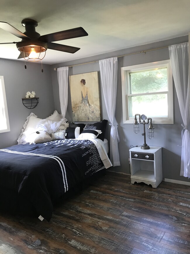 Second bedroom. Flooring pictured runs throughout this entire apartment villa. Completely remodeled, brand new mattress and luxurious bedding. - 502 Crab Apple Ct