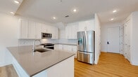 Located at 4115 Lake St in Alpharetta, GA, this well-appointed two-story home offers 2 bedrooms and 2 bathrooms across two thoughtfully laid-out floors. The main level provides a generous footprint centered around an open-concept kitchen and living area. The kitchen is a standout feature, showcasing white shaker cabinetry, subway tile backsplash, quartz countertops, stainless steel appliances including a gas range and French door refrigerator, and a large center island with an undermount sink — ideal for both cooking and entertaining. Light wood flooring flows consistently throughout both levels, lending warmth and continuity to the space. The upper level houses the bedrooms, including a spacious primary suite with multiple windows, a ceiling fan, and ample natural light. The primary bathroom features a dual-sink vanity with a dark quartz countertop, white cabinetry, and a large framed mirror with overhead lighting. Three closets — including a walk-in with wire shelving — provide practical storage solutions. A private balcony off the upper level offers open-air views of the surrounding community and pool area. Clean white walls and recessed lighting throughout give the home a bright, modern aesthetic.