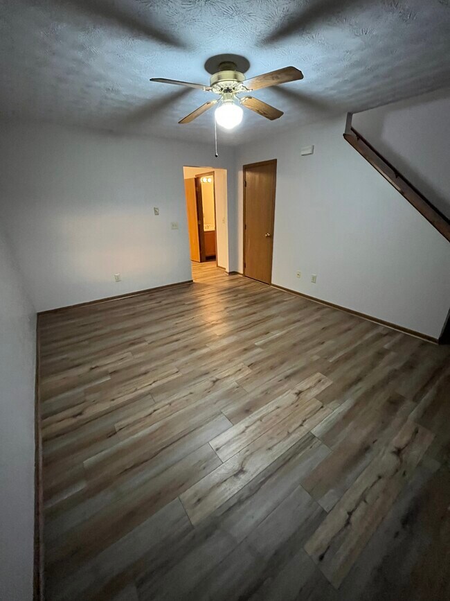 Living Room on First Floor. Access to Front Door, Upstairs, Kitchen, and Closet. - 1540 Windridge Pl