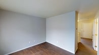 This two-story residence offers a well-organized layout across two floors, featuring two bedrooms and one and a half bathrooms. The space is designed with a clean, modern aesthetic, highlighted by neutral gray walls and warm, dark hardwood-style flooring that runs throughout the living areas, creating a cohesive and inviting atmosphere. The light-toned ceilings complement the soft wall colors, contributing to a bright and airy feel. Each bedroom provides a comfortable and functional space, with clean lines and a neutral palette that offers a versatile canvas for personalization. The half bathroom on one level adds convenience for guests, while the full bathroom serves the private quarters. The two-floor configuration creates a natural separation between living and sleeping areas, enhancing privacy and functionality. White baseboards provide a crisp contrast to the flooring, adding a polished finishing touch to each room. Overall, this home balances simplicity and practicality, making it a well-suited space for everyday living.