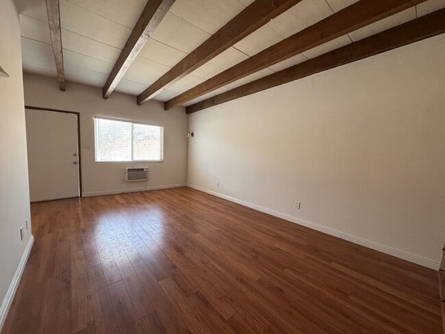Building Photo - Large and Bright Studio with wood ceiling beams and floors...