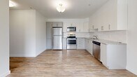 Located at 728 Meaford Ave in Langford, BC, this 2-bedroom, 1-bathroom unit offers a well-designed single-floor layout with a clean, contemporary aesthetic throughout. The open kitchen is a standout feature, showcasing white cabinetry with sleek hardware, a classic white subway tile backsplash, granite-look countertops, and a full suite of stainless steel appliances including a refrigerator, stove, built-in microwave, and dishwasher. Light wood-look flooring runs through the kitchen and living area, lending warmth and continuity to the space, while a window brings in natural light and frames views of surrounding greenery. Both bedrooms are finished with neutral-toned carpet, crisp white walls, and clean white baseboards, creating comfortable and versatile spaces. The primary bedroom includes a closet with a panelled bifold door, providing practical storage. The bathroom features a full-sized soaker tub and shower combination with bright white surrounds and chrome fixtures. A dedicated hallway connects the rooms, contributing to an efficient and functional floor plan. The overall design is modern, minimalist, and move-in ready, making it an ideal space for those seeking comfortable urban living in the Langford community.