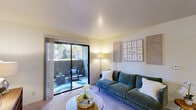 Located at 3500 Data Dr in Rancho Cordova, CA, this well-appointed 2-bedroom, 1-bathroom residence offers a thoughtfully designed single-floor layout. The inviting living room features soft carpeting, warm neutral tones, and a sliding glass door that floods the space with natural light and opens to a private outdoor patio — ideal for relaxing or entertaining. The galley-style kitchen is well-equipped with white cabinetry, dark granite-style countertops, black appliances including a range and refrigerator, and wood-look flooring. A pass-through view connects the kitchen to a cozy dining nook with bar-height seating. The spacious primary bedroom offers a generous closet with built-in shelving and comfortable carpet flooring, while the second bedroom is bright and cozy, benefiting from a large window with outdoor views. Both rooms provide a calm, restful atmosphere. The full bathroom features a tub-shower combination, a wide vanity with a large mirror and bright lighting, and dark countertops that complement the white cabinetry. An in-unit laundry area adds everyday convenience. Throughout the residence, a cohesive palette of soft neutrals and warm finishes creates an approachable and comfortable living environment.
