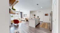 Located at 1226 Bexton St in Charlotte, NC, this single-floor residence offers a well-designed open-concept layout that seamlessly connects the kitchen and living areas. The kitchen is a standout feature, equipped with stainless steel appliances, white shaker-style cabinetry with subway tile backsplash, granite countertops, and a central island with a built-in sink — ideal for both everyday cooking and entertaining. Wood-style flooring flows throughout the main living spaces, adding warmth and continuity.

The living room is bright and welcoming, with large windows fitted with blinds and drape panels that allow for ample natural light, complemented by a ceiling fan overhead. A glass door provides access to an outdoor area, further enhancing the sense of openness.

The residence includes two bedrooms, each featuring plush carpeting, generous windows with natural light, and ceiling fans. Both bathrooms are finished with granite-topped vanities and wood-style flooring; one includes a shower-tub combination, while the other features a walk-in shower. The clean, neutral palette throughout the home creates a cohesive and modern aesthetic, making this Charlotte residence a functional and stylish living space.
