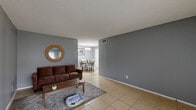 Located at 101 S Allen Genoa Rd in South Houston, TX, this one-bedroom, one-bathroom unit offers a practical and well-organized single-floor layout. Consistent light tile flooring runs throughout, lending a cohesive and easy-to-maintain feel across all rooms. The living room is a comfortable, open space bathed in natural light from a large window, with neutral gray walls that create a calm, modern atmosphere. Adjacent to the living area, the dedicated dining space features a ceiling-mounted light fixture and offers a defined area for meals. The kitchen is efficiently designed with crisp white cabinetry, granite countertops, a mosaic tile backsplash, and a stainless steel sink — providing both functionality and a clean aesthetic. The bedroom is a well-proportioned retreat featuring a ceiling fan with light, a window with outdoor views, and its own closet. The bathroom includes a vanity with granite countertops, tile flooring, and a tub-shower combination with tiled surround. Textured ceilings are present throughout the unit. This space offers a straightforward, comfortable layout suited for everyday living in South Houston.