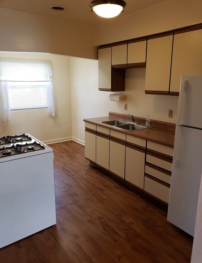 Kitchen with fridge, oven, range, and sink - 713 John St