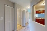 Located at 17400 Cedar Lake Cir in Northville, Michigan, this one-bedroom, one-bathroom residence offers a well-organized single-floor layout designed for comfortable, everyday living. Neutral gray walls and light wood-look tile flooring in the main corridors create a clean, cohesive aesthetic throughout.

The open-concept kitchen is a functional highlight, featuring warm cherry wood cabinetry, granite countertops, stainless steel appliances including a refrigerator and range, and a pass-through breakfast bar that connects directly to the living area. This seamless connection makes the space feel open and sociable. The living room is carpeted and benefits from natural light streaming through large windows with blinds.

The bedroom is a comfortable, well-proportioned retreat with plush carpeting, a ceiling fan with light fixture, and generous natural light from a window overlooking the outdoors. A dedicated closet provides ample storage. The hallway also features a louvered closet, and in-unit washer and dryer hookups are conveniently located off the main corridor.

The bathroom is finished with light tile flooring, a warm wood vanity with a granite-topped sink, a wall mirror framed by a lighted vanity bar, and a clean, bright atmosphere. The overall design of this residence is practical and inviting, offering a move-in-ready environment in a desirable Northville location.