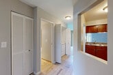 Located at 17400 Cedar Lake Cir in Northville, Michigan, this one-bedroom, one-bathroom residence offers a well-organized single-floor layout designed for comfortable, everyday living. Neutral gray walls and light wood-look tile flooring in the main corridors create a clean, cohesive aesthetic throughout.

The open-concept kitchen is a functional highlight, featuring warm cherry wood cabinetry, granite countertops, stainless steel appliances including a refrigerator and range, and a pass-through breakfast bar that connects directly to the living area. This seamless connection makes the space feel open and sociable. The living room is carpeted and benefits from natural light streaming through large windows with blinds.

The bedroom is a comfortable, well-proportioned retreat with plush carpeting, a ceiling fan with light fixture, and generous natural light from a window overlooking the outdoors. A dedicated closet provides ample storage. The hallway also features a louvered closet, and in-unit washer and dryer hookups are conveniently located off the main corridor.

The bathroom is finished with light tile flooring, a warm wood vanity with a granite-topped sink, a wall mirror framed by a lighted vanity bar, and a clean, bright atmosphere. The overall design of this residence is practical and inviting, offering a move-in-ready environment in a desirable Northville location.