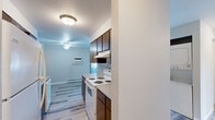 Located at 1904 E South Riverton Ave in Spokane, WA, this two-bedroom, one-bathroom residence offers a practical and comfortable single-floor layout. The open-concept kitchen and living area feature warm hardwood-style flooring, a functional kitchen with wood-toned cabinetry, a built-in stovetop, and ample counter space — ideal for everyday cooking and entertaining. A hallway connects the main living areas to the private bedrooms and bathroom.

Both bedrooms are carpeted and finished with neutral gray walls, providing a calm and restful atmosphere. Each room is equipped with a ceiling fan with integrated lighting, a baseboard heater for year-round comfort, and a window with blinds that allows natural light while maintaining privacy. The primary bedroom offers a generous footprint and includes a sliding-door closet for convenient storage. The second bedroom is similarly well-proportioned and versatile in use.

The full bathroom is clean and functional, featuring a combined tub and shower unit with a curved curtain rod, hardwood-style flooring, and neutral gray walls that create a cohesive look throughout the home. The overall design is straightforward and move-in ready, with consistent finishes and practical amenities throughout.