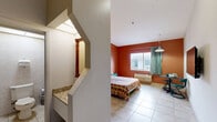 This 290 square foot studio apartment, located at 935 W Okeechobee Rd in Hialeah, FL, offers a compact yet functional living space. The room is characterized by its striking terracotta accent wall, which adds warmth and character to the otherwise neutral color palette. Large windows provide natural light and a view of the surrounding area, while teal curtains offer privacy when needed.

The efficient layout combines sleeping and living areas, featuring a full-sized bed with a colorful patchwork quilt. A wall-mounted flat-screen TV and a small dining table with teal chairs maximize the use of space. The room is equipped with modern amenities, including a wall-mounted air conditioning unit for comfort in Florida's climate.

The flooring throughout is tiled, providing a clean and low-maintenance surface. Lighting is provided by a central pendant fixture and wall-mounted sconces, creating a layered lighting scheme. The bathroom, though compact, is fully functional with a toilet, sink, and what appears to be a shower area (not visible in the image), all finished with neutral-toned tiles.

Despite its small footprint, the studio offers all essential living spaces, making efficient use of its 290 square feet. The design choices, particularly the bold accent wall and coordinated teal furnishings, create a cohesive and inviting atmosphere in this compact urban dwelling.