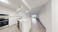 Located at 3600 Jackson St in Hollywood, Florida, this well-appointed 1-bedroom, 1-bathroom unit offers a thoughtfully designed single-floor layout with a clean, modern aesthetic throughout. Light-toned wood-look tile flooring extends seamlessly across every room, creating a cohesive and easy-to-maintain interior.

The living room is bright and open, benefiting from natural light through windows dressed with vertical blinds. A half-wall partition separates the living area from the kitchen, maintaining an open feel while defining each space. The kitchen is fully equipped with stainless steel appliances — including a refrigerator, electric range with oven, and dishwasher — paired with crisp white cabinetry, light countertops, and a single-basin sink. Ample cabinet storage lines both walls of the galley-style layout.

The spacious primary bedroom accommodates generous proportions and includes a dedicated closet with built-in shelving, along with a window that allows natural light to filter in. The bathroom features a full tub-shower combination with large-format white wall tile, a toilet, and matching light flooring, maintaining the home's clean, neutral palette throughout. The unit's bright white walls and flush ceiling lighting contribute to an airy, well-lit ambiance across all rooms.