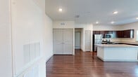 Located at 100 Lasa Drive in St. Augustine, FL, this well-appointed one-bedroom, one-bathroom residence offers a thoughtful single-floor layout designed for comfortable living. The open-concept main area seamlessly combines the living room, dining room, and kitchen, creating a bright and cohesive space. Rich hardwood-style flooring flows throughout the main living areas, adding warmth and continuity to the design.

The kitchen is a standout feature, showcasing dark espresso cabinetry, light granite countertops, a center island, and a full suite of stainless steel appliances including a refrigerator, range, microwave, and dishwasher. Recessed lighting illuminates the space effectively.

The bedroom is carpeted for comfort, features a ceiling fan with light fixture, and benefits from a natural light-providing window with an outdoor view. A generously sized walk-in closet with wire shelving offers ample storage. Two additional closets provide further organizational flexibility, complemented by a dedicated pantry and laundry area.

The bathroom includes a dark wood vanity with granite countertop, a full tub-shower combination, and consistent hardwood-style flooring. A hallway and entrance area complete the functional layout, making this a well-rounded residence in a desirable Florida location.