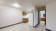 This 570 square foot apartment in Fond du Lac, Wisconsin, offers a practical and efficient living space. The single-floor layout comprises one bedroom, one bathroom, and a kitchen, making it suitable for individuals or couples. The primary bedroom, measuring 150 square feet, provides ample space and features two windows that allow natural light to flood the room. The apartment boasts modern finishes throughout, with light-colored laminate flooring that unifies the space and creates a contemporary feel. The kitchen is equipped with wooden cabinets, white appliances, and a clean, linear design that maximizes functionality in the compact space. The bathroom, while not spacious, offers essential amenities. The living areas are characterized by neutral-toned walls, creating a blank canvas for personalization. Baseboard heating units are visible, ensuring comfort during Wisconsin's colder months. The windows throughout the apartment are fitted with horizontal blinds, offering privacy and light control. Overall, this apartment presents a well-designed, low-maintenance living option in a convenient Fond du Lac location.