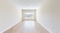 Located at 120 Chamberlain Dr in Asheville, NC, this single-floor, 2-bedroom, 2-bathroom home offers a practical and comfortable layout. Wood-look flooring flows consistently throughout every room, providing a cohesive and easy-to-maintain finish.

The kitchen is well-equipped with warm honey-toned cabinetry, dark countertops, and a full suite of black appliances including a refrigerator, range, and over-the-range microwave. A peninsula with a sink adds additional counter space and separates the kitchen from the adjacent living area, creating an open, connected feel.

The living room receives generous natural light through large windows fitted with horizontal blinds, with views of surrounding greenery. Both bedrooms are comfortably sized, each featuring ceiling fans with light fixtures and windows that bring in additional natural light. The primary bedroom is notably spacious and includes access to a dedicated closet.

Both bathrooms are finished consistently, featuring white vanity cabinetry, light countertops, large mirrors with overhead vanity lighting, and wood-look flooring that ties back to the rest of the home. The neutral, warm beige tones used throughout the walls give the entire space a clean, move-in-ready appearance.
