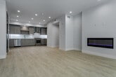Located at 5955 Saturn St in the heart of Los Angeles, this modern single-floor unit showcases a clean, contemporary design throughout. The open kitchen is a standout feature, outfitted with light wood-grain cabinetry, white quartz countertops, a decorative hexagonal tile backsplash, and a full suite of stainless steel appliances including a gas range, dishwasher, and French door refrigerator. Light hardwood-style flooring and recessed lighting complete the kitchen's bright, functional aesthetic. The bedrooms are finished with plush carpeting and feature large black-framed windows that invite abundant natural light. One bedroom offers sweeping views of the surrounding Los Angeles neighborhood, while others include sliding-door closets with built-in shelving for ample storage. Pendant lighting accents one of the bedrooms, adding a refined touch. The bathrooms are well-appointed with wood-tone vanity cabinetry, white quartz countertops, and large mirrors. The primary bathroom features a glass-enclosed tub-shower combination, while a second bathroom includes hexagonal tile flooring and a tub-shower with gold-toned framed glass doors. Throughout, the space maintains a cohesive, modern palette of whites and warm neutrals, creating a bright and inviting atmosphere.