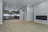 Located at 5955 Saturn St in the heart of Los Angeles, this modern single-floor unit showcases a clean, contemporary design throughout. The open kitchen is a standout feature, outfitted with light wood-grain cabinetry, white quartz countertops, a decorative hexagonal tile backsplash, and a full suite of stainless steel appliances including a gas range, dishwasher, and French door refrigerator. Light hardwood-style flooring and recessed lighting complete the kitchen's bright, functional aesthetic. The bedrooms are finished with plush carpeting and feature large black-framed windows that invite abundant natural light. One bedroom offers sweeping views of the surrounding Los Angeles neighborhood, while others include sliding-door closets with built-in shelving for ample storage. Pendant lighting accents one of the bedrooms, adding a refined touch. The bathrooms are well-appointed with wood-tone vanity cabinetry, white quartz countertops, and large mirrors. The primary bathroom features a glass-enclosed tub-shower combination, while a second bathroom includes hexagonal tile flooring and a tub-shower with gold-toned framed glass doors. Throughout, the space maintains a cohesive, modern palette of whites and warm neutrals, creating a bright and inviting atmosphere.