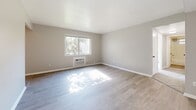 Located at 4052 Fulton Rd in Cleveland, Ohio, this one-bedroom, one-bathroom unit offers a thoughtfully laid-out single-floor plan with a clean, neutral aesthetic throughout. The living area features light-toned hardwood-style flooring, soft gray walls, and a large window that allows natural light to pour in, creating a bright and welcoming atmosphere. A wall-mounted AC unit provides in-unit climate control.

The galley-style kitchen is a standout feature, showcasing crisp white cabinetry with matte black hardware, warm wood butcher block countertops, a white subway tile backsplash, and a stainless steel sink. White appliances, including a gas range and refrigerator, complete the functional cooking space. Light hardwood-style flooring runs throughout the kitchen, tying the space together seamlessly.

The bedroom is a comfortably sized retreat finished with plush carpet flooring, neutral walls, and a flush-mount ceiling light. A wide sliding-door closet provides generous storage, complemented by a standard entry door for added privacy.

The bathroom features a full-size soaking tub enclosed by classic white subway tile surround, with a small window above allowing in natural light while maintaining privacy.

A connecting hallway links the main areas of the unit, contributing to a logical and easy-to-navigate floor plan. The overall ambiance is clean, simple, and move-in ready.