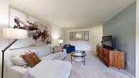 Located at 41 Fir House in Douglassville, PA, this single-floor residence offers a well-organized layout with two bedrooms, one bathroom, a kitchen, and a combined living and dining area. The living room features soft carpeting, neutral walls, and an open feel, providing a comfortable gathering space. A distinctive accent wall adds a subtle architectural detail that separates the living area from the rest of the home. The dining area is positioned adjacent to the kitchen and benefits from natural light through a window with outdoor views, complemented by warm hardwood-style flooring. The kitchen is efficiently designed with white cabinetry, dark countertops, hardwood-style floors, and includes a range, dishwasher, and ample counter and storage space. The primary bedroom is a well-proportioned retreat with plush carpeting, a large window that brings in natural light, and room for a full bedroom suite. The second bedroom also features carpet flooring and includes a sliding-door closet, offering functional storage. The bathroom is finished with classic white tile accents, a vanity with storage, and a tub/shower combination. Overall, the residence presents a clean, straightforward layout suited for practical, comfortable living.