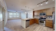 This 1040 square foot apartment, located in The Enclave, offers a thoughtfully designed living space with two bedrooms and two bathrooms. The primary bedroom is generously sized at 220 square feet, providing ample space for relaxation and storage. The apartment features a modern kitchen with wooden cabinetry, granite countertops, and stainless steel appliances, including a gas range and built-in microwave. The open-concept living area seamlessly connects to the kitchen, creating an ideal space for entertaining.

Both bathrooms are well-appointed with large vanities, modern fixtures, and a combination of tile and carpet flooring. The shower/tub combinations feature decorative tile accents, adding a touch of elegance. Large windows throughout the apartment allow for plenty of natural light, while ceiling fans in the bedrooms and living area provide additional comfort. The apartment also includes a spacious walk-in closet with adjustable shelving systems for maximized storage. The neutral color palette and carpeted floors in the bedrooms and living areas create a warm and inviting atmosphere, ready for personalization.