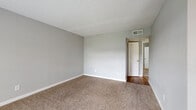 Located at 900 N Durham Dr in Houston, TX, this single-story one-bedroom, one-bathroom unit offers a functional and well-appointed layout. The living room serves as the welcoming entry point, featuring warm hardwood flooring, neutral gray walls, a textured ceiling, and a window with blinds that allows natural light to brighten the space. The transition from the entry area to the living space is defined by a shift from hardwood to plush carpet, adding comfort underfoot. The kitchen is equipped with rich, warm-toned wood cabinetry, granite-style countertops, a stainless steel sink, and a full-size refrigerator, providing ample storage and workspace. The spacious bedroom is finished with soft carpet flooring, a ceiling fan with light fixture, a window overlooking the outdoors, and access to a dedicated walk-in closet, offering generous storage. The full bathroom features hardwood flooring, a tiled tub-and-shower combination with floor-to-ceiling tile surround, a toilet, and a vanity with wood cabinetry. Additional highlights include a dedicated laundry area, two closets, and a hallway connecting the rooms. The unit's clean, neutral palette and practical layout provide a comfortable living environment.