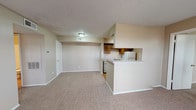 Located at 1305 Woodrow Rd in Lubbock, Texas, this single-floor unit offers a practical and functional layout throughout. The open living area is finished with wall-to-wall carpet and features a tile-surround fireplace, providing a welcoming focal point. A large window allows natural light to fill the space, enhancing its warm, neutral color palette. The kitchen is designed in a galley style, lined with rich, dark wood cabinetry on both sides and equipped with white appliances including a refrigerator, electric range, and dishwasher. Light wood-style flooring runs through the kitchen, which connects seamlessly to the living area via a peninsula counter. The bedrooms are carpeted and each features a ceiling fan with light fixture and a window with blinds, offering a comfortable and well-ventilated environment. The bathroom includes a full tub and shower combination with white subway tile surround, complemented by wood-style flooring and a vanity with countertop. Additional storage is provided through closet space accessible from the hallway. Textured ceilings are consistent throughout, and the overall design reflects a clean, straightforward aesthetic suited for everyday living.