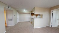 Located at 1305 Woodrow Rd in Lubbock, Texas, this single-floor unit offers a practical and functional layout throughout. The open living area is finished with wall-to-wall carpet and features a tile-surround fireplace, providing a welcoming focal point. A large window allows natural light to fill the space, enhancing its warm, neutral color palette. The kitchen is designed in a galley style, lined with rich, dark wood cabinetry on both sides and equipped with white appliances including a refrigerator, electric range, and dishwasher. Light wood-style flooring runs through the kitchen, which connects seamlessly to the living area via a peninsula counter. The bedrooms are carpeted and each features a ceiling fan with light fixture and a window with blinds, offering a comfortable and well-ventilated environment. The bathroom includes a full tub and shower combination with white subway tile surround, complemented by wood-style flooring and a vanity with countertop. Additional storage is provided through closet space accessible from the hallway. Textured ceilings are consistent throughout, and the overall design reflects a clean, straightforward aesthetic suited for everyday living.