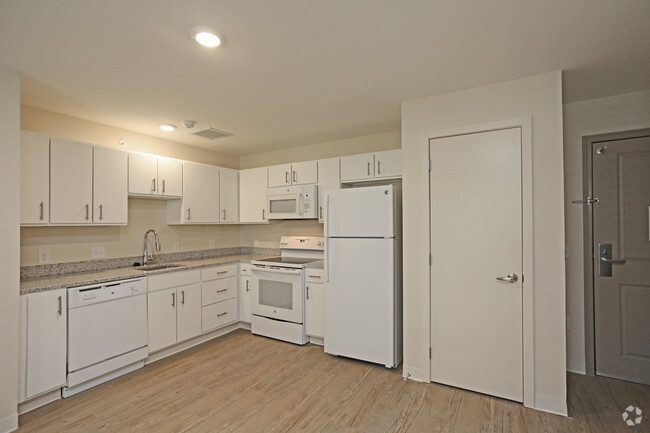 Kitchen complete with sink, garbage disposal, dishwasher, oven, stove, refrigerator, freezer, and microwave - Parks Residential - Richardson