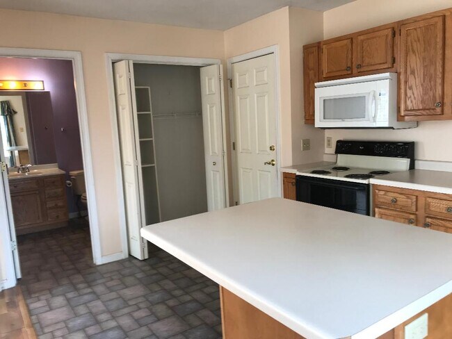 Kitchen looking at bathroom,closet and door to laundry. - 1013 Oak Hill St