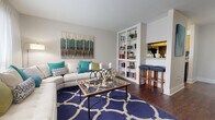 This single-floor residence at 8000 W Tidwell Rd in Houston, TX offers a thoughtfully laid-out interior with a cohesive design throughout. The open living room is a standout space, featuring rich hardwood-style flooring, large windows that invite natural light, and a built-in white bookcase that adds both storage and character. A pass-through to the kitchen enhances the open feel of the entertaining area.

The galley-style kitchen is efficiently designed with warm wood cabinetry, granite-style countertops, dark tile backsplash, and black appliances including a range, refrigerator, and dishwasher — all complemented by the same durable hardwood-style flooring.

The dining area accommodates a full-size table and benefits from its proximity to both the kitchen and a dedicated laundry nook. The bedrooms are carpeted for comfort, with one featuring a walk-in closet and another offering generous space and natural light through window treatments. The bathroom presents a clean, bright aesthetic with a soaking tub, granite-topped vanity, and crisp white finishes throughout. Overall, the space delivers a functional and inviting layout well-suited for everyday living in the heart of Houston.
