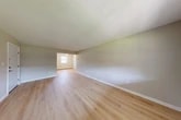 Located at 44 Center Grove Road in Randolph, NJ, this single-floor, one-bedroom, one-bathroom unit offers a clean and functional layout with consistent light hardwood flooring throughout. The open living and dining areas are bright and airy, benefiting from natural light through double-hung windows, and feature neutral-toned walls that create a calm, cohesive ambiance. A wall-unit HVAC system and baseboard heating ensure year-round comfort. The kitchen is a standout feature, showcasing warm honey-toned wood cabinetry with raised-panel detailing, white quartz countertops, a subway tile backsplash, and a stainless steel sink — providing ample storage and prep space. The spacious bedroom includes access to a dedicated closet as well as proximity to the full bathroom, which is equipped with a tiled tub-shower combination, a window for natural light, and clean white finishes. Three closets are distributed throughout the unit, offering excellent storage capacity. A hallway connects the living areas to the private spaces, contributing to a logical and efficient floor plan. The unit's neutral palette, updated finishes, and well-maintained condition make it a comfortable and move-in ready space in Randolph, NJ.