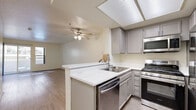 Located at 930 Figueroa Terrace in Los Angeles, this 2-bedroom, 2-bathroom unit offers a thoughtfully organized single-floor layout. The living room serves as the central gathering space, featuring light wood-style flooring, neutral cream-toned walls, and a sliding glass door that opens to a private balcony, inviting natural light and outdoor views into the space.

Both bedrooms continue the wood-style flooring theme and are fitted with mirrored sliding closet doors that reflect light and enhance the sense of space. The primary bedroom benefits from multiple windows with views of the surrounding exterior, while the second bedroom offers a quieter, more enclosed feel with its own ample closet storage.

The two bathrooms are clean and functional, each outfitted with wood-style flooring, light stone-finish countertops, and a full bathtub-shower combination complete with grab bars. The bright, white fixtures and neutral palette create a fresh, streamlined aesthetic throughout.

A connecting hallway links the bedrooms and bathrooms, providing a logical and efficient flow through the unit. The kitchen, visible in the floor plan, is positioned adjacent to the living area for convenient access. Overall, the unit presents a bright, neutral, and move-in-ready environment well-suited for comfortable urban living in Los Angeles.
