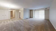 Located at 7085 W 130th St in Parma Heights, Ohio, this 2-bedroom, 2-bathroom unit offers a functional and comfortable single-floor layout. The open living area features neutral-toned carpet, a textured ceiling, and vertical blind-covered sliding doors that allow natural light to flow through the space. The layout connects the living area seamlessly to the kitchen and bedroom hallway, providing an efficient flow throughout.

The kitchen is well-equipped with white cabinetry, granite-style countertops, stainless steel appliances including a gas range, microwave, and dishwasher, and durable wood-look flooring. A window with vertical blinds adds natural light to the cooking space.

Both bedrooms are carpeted and feature neutral wall tones with vertical blind-covered windows that bring in outside light. The primary bedroom offers a generous footprint with ample space for furniture arrangement, while a closet provides convenient built-in storage.

The two bathrooms are finished with white vanity cabinetry, updated fixtures, a mirrored medicine cabinet, and wood-look flooring, giving them a clean and modern feel. Soft, neutral tones throughout the unit create a cohesive and inviting atmosphere well-suited for everyday living.