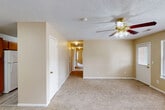 Located at 208 Southwind Dr in Athens, Alabama, this single-story, 4-bedroom, 2-bathroom home offers a functional and comfortable layout designed to maximize everyday living. The living room serves as the heart of the home, featuring warm neutral tones, plush carpeting, a textured ceiling, and a ceiling fan with a light fixture—creating a welcoming and practical space. A central hallway connects the living area to the bedrooms, maintaining an efficient and organized flow throughout the home. The kitchen is laid out in a galley style, featuring warm oak cabinetry, white countertops, a double-basin sink, and appliances including an electric range and refrigerator. Light wood-look flooring runs through the kitchen, adding a clean, modern touch. Each of the four bedrooms is finished with either light wood-look flooring or carpet, neutral walls, and individual ceiling fixtures—several rooms also include ceiling fans. Natural light enters through blinds-fitted windows. The bathrooms each include a full tub/shower combination. Four closets are distributed throughout the home for ample storage. A dedicated laundry room adds further convenience to this well-organized single-floor residence.